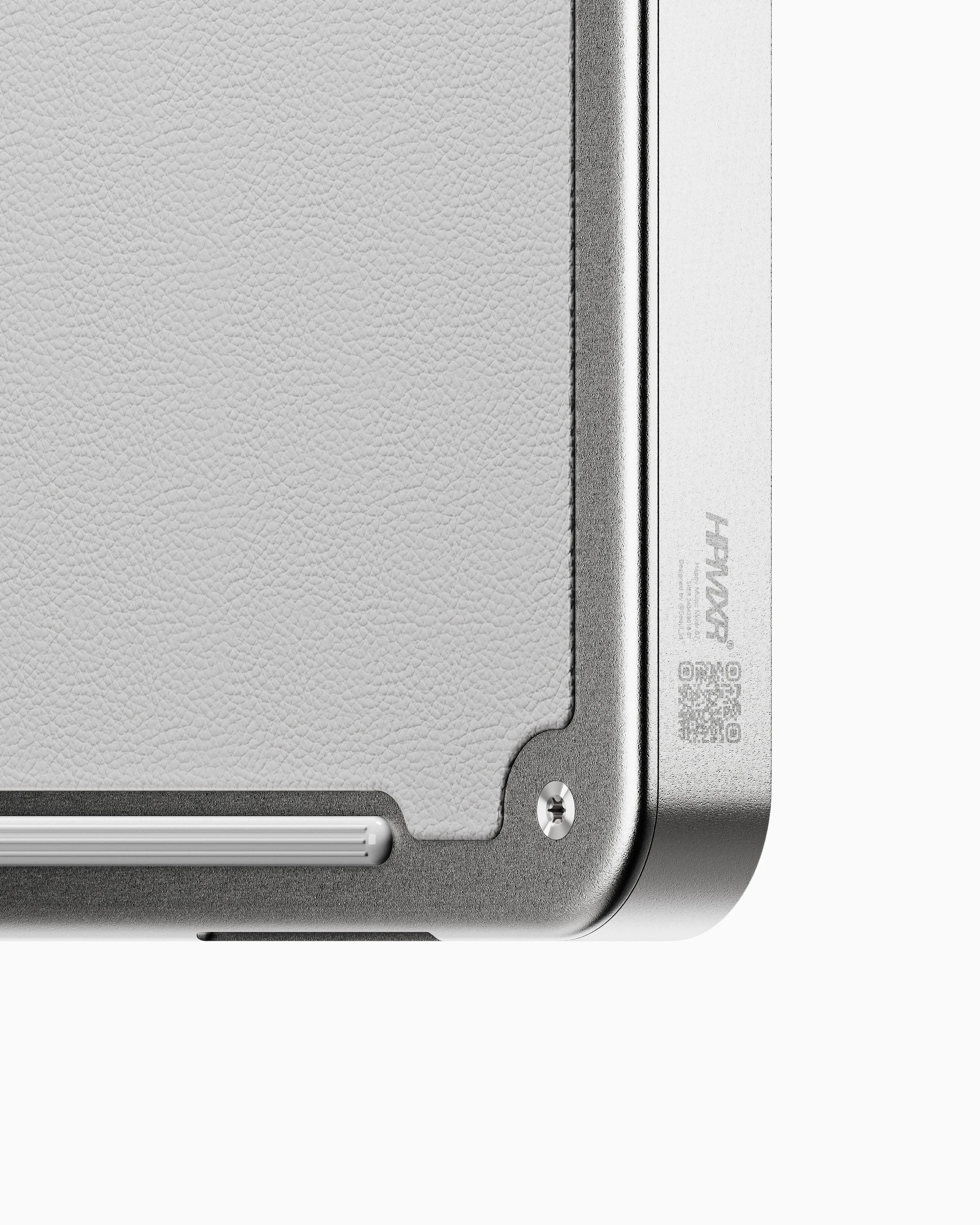 Macro view of the HPMXR07 leather surface, metal frame, fastener and engraved rear label