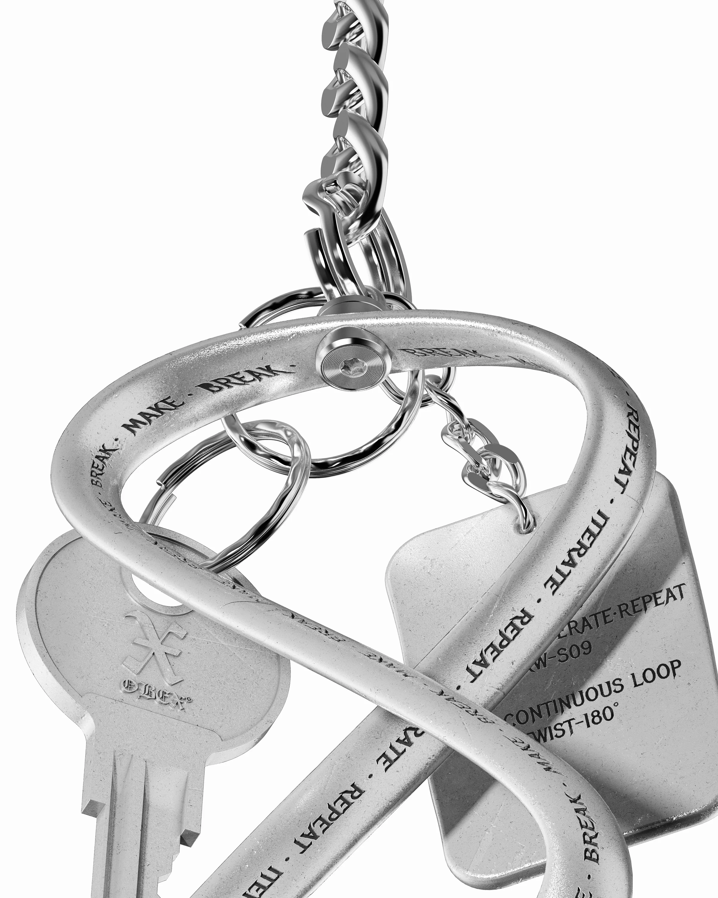 Close-up of the Möbius loop pivot, engraved text and surrounding keychain hardware