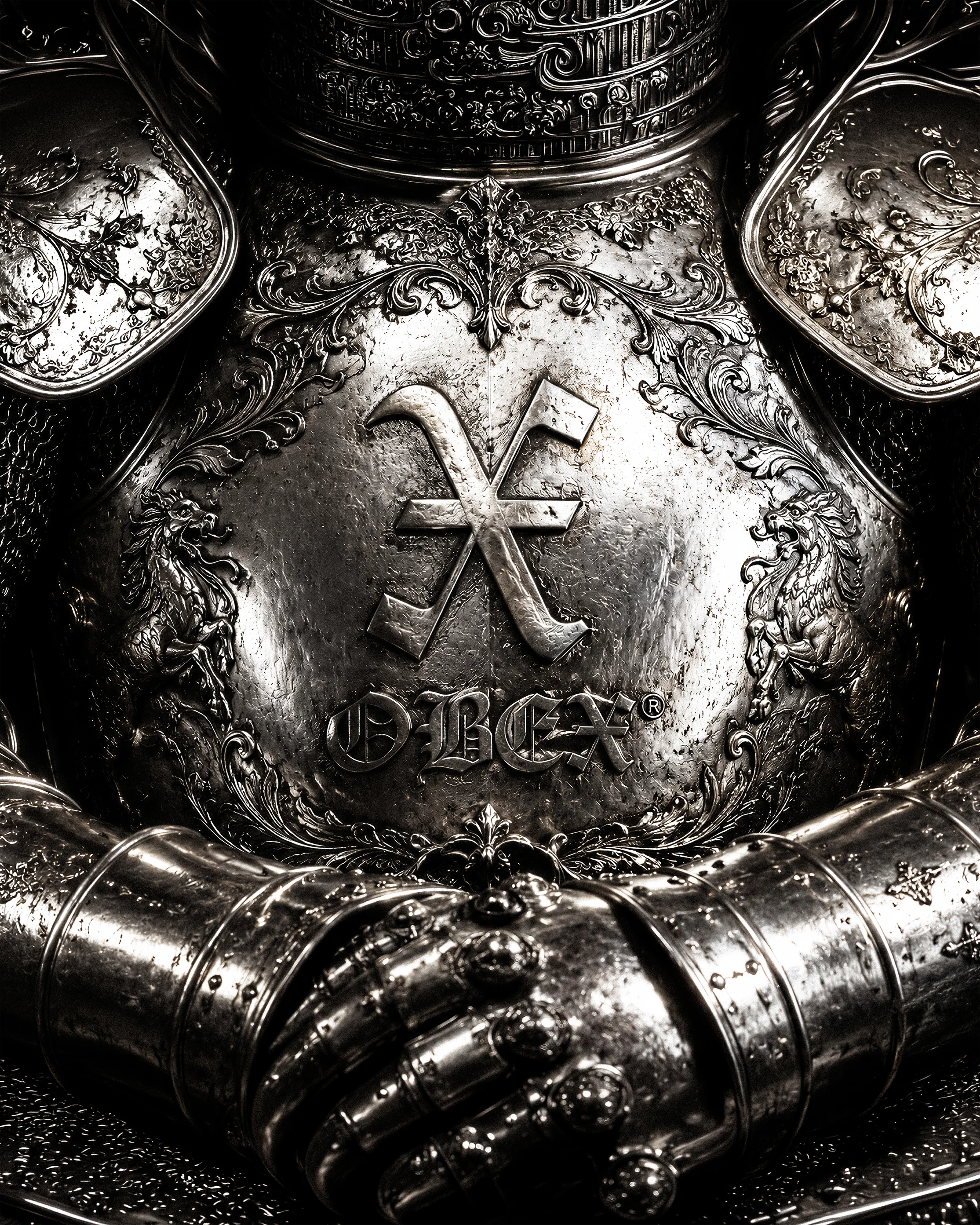 OBEX symbol and wordmark applied to an engraved metal armor surface