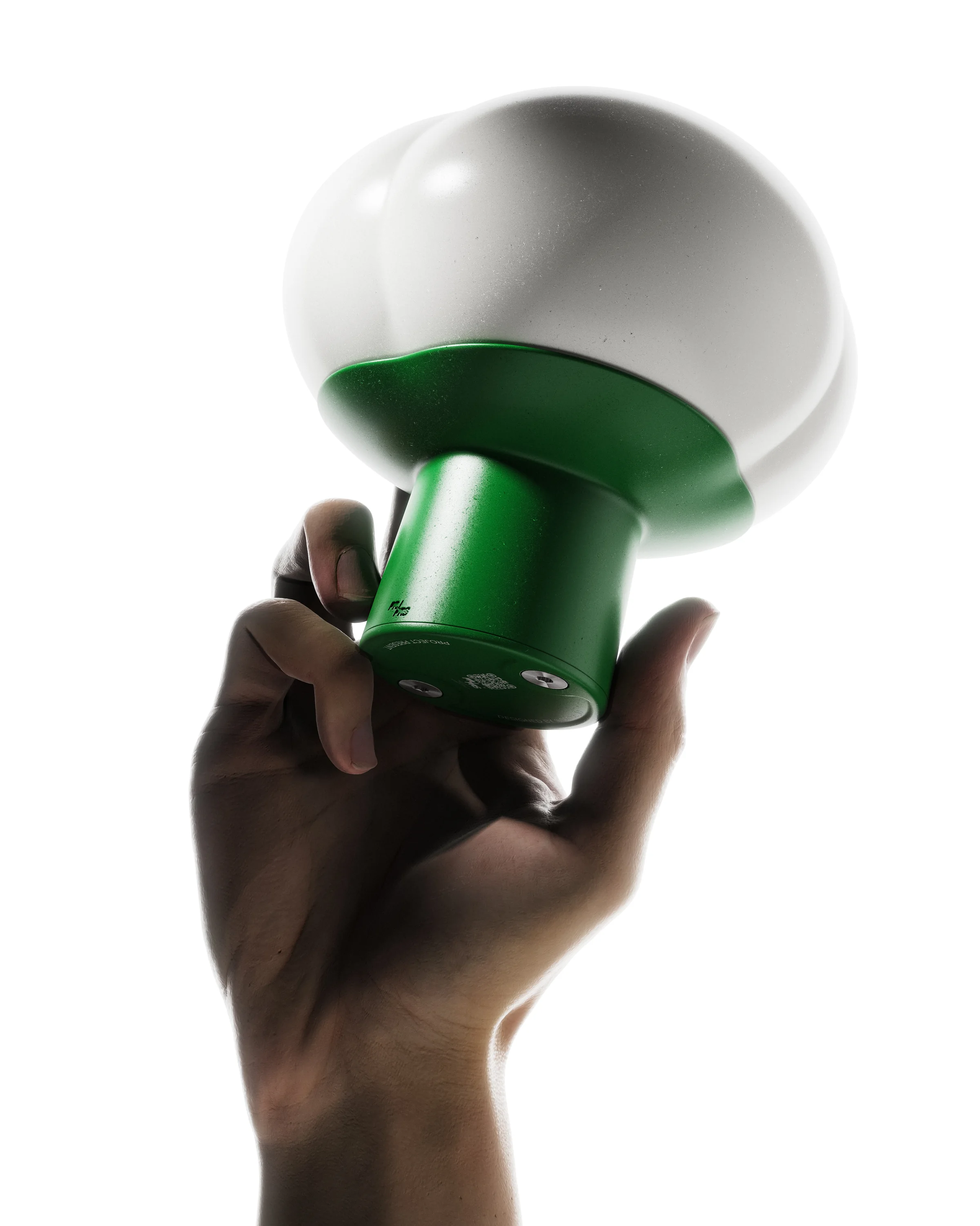 Clover portable light held in one hand with a green body and softly glowing petal-shaped diffuser