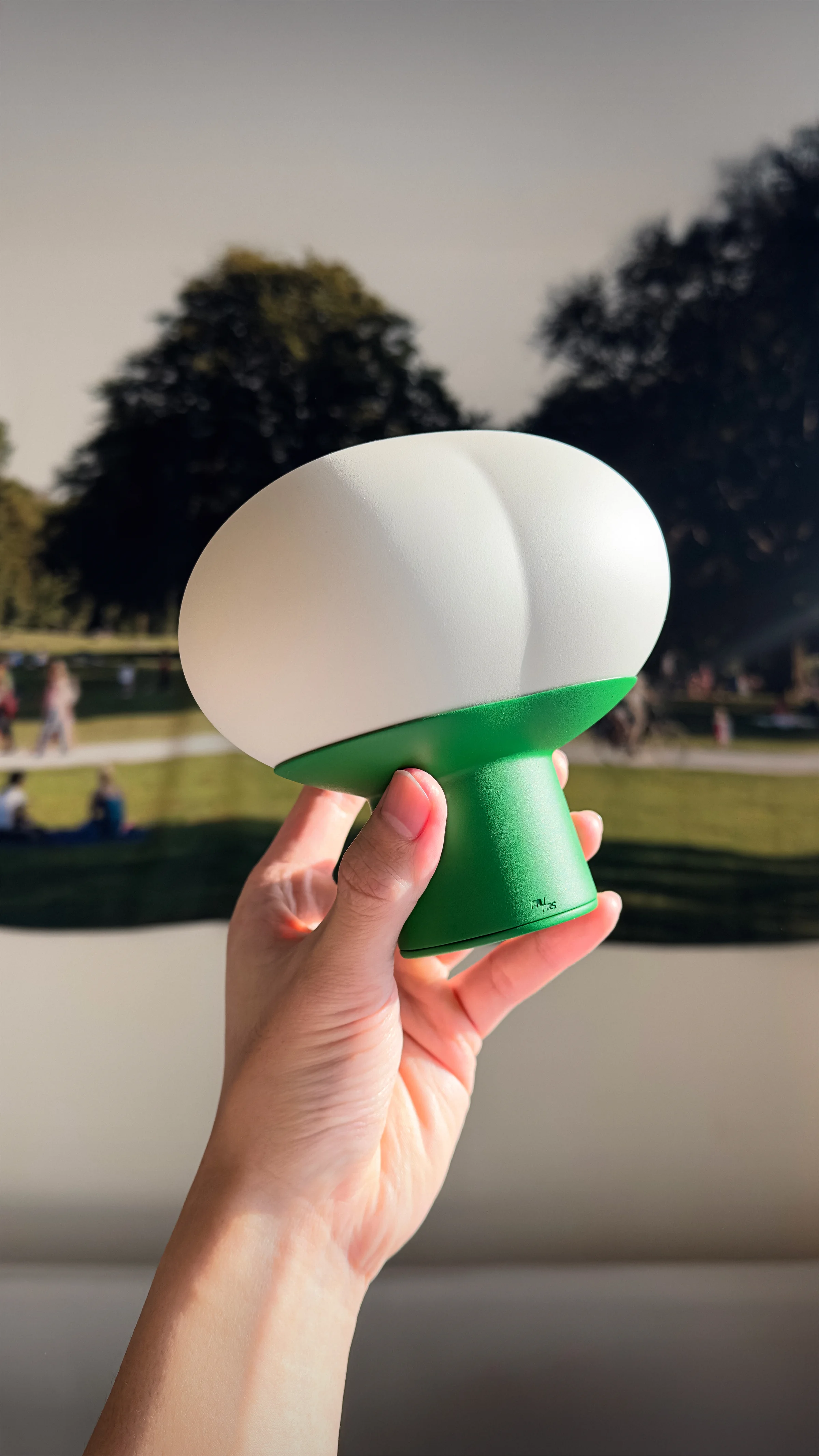Physical Clover lighting prototype held outdoors to show its handheld scale