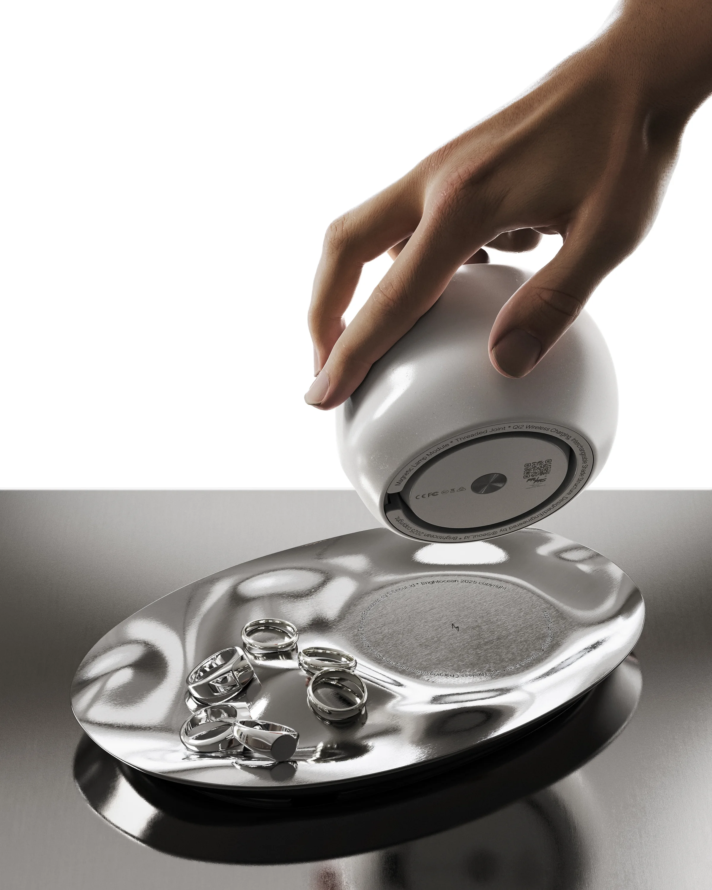 Yunseul lamp module lifted from an organically shaped reflective metal surface